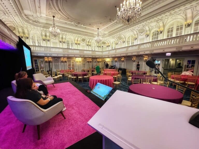 Wide shot of Power+ Summit stage with screens and lighting